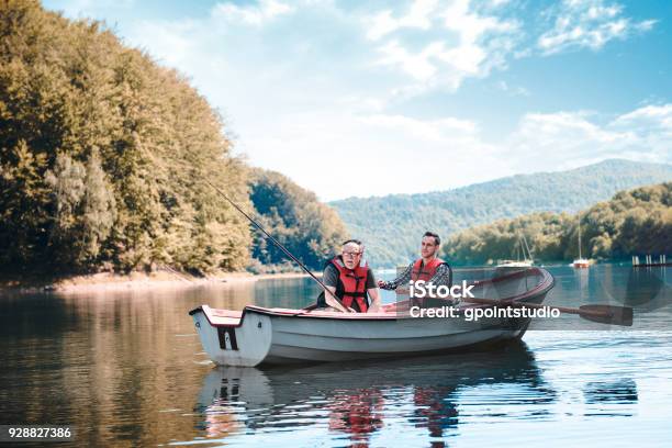 Fishing By The Lake Is Their Common Passion Stock Photo - Download Image Now - Fishing, Fishing Industry, Rowboat