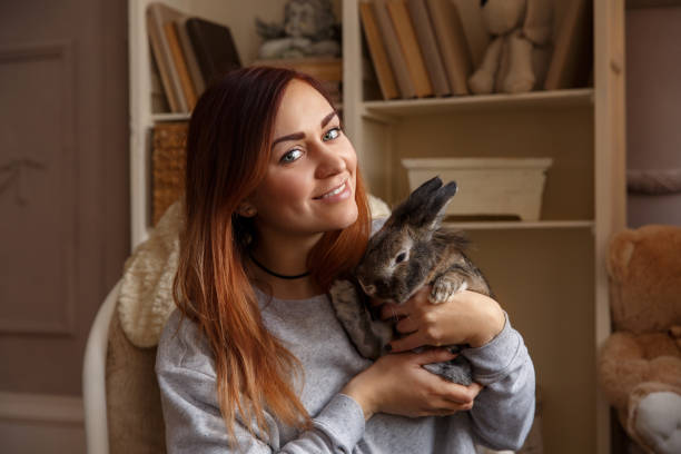 istock Happy woman holding Easter bunny and smiling to camera at Easter day 928830086