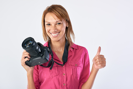 Confident woman holding dslr camera, completed  a successful learning course