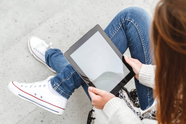 istock Girl with a tablet in hands 928836668