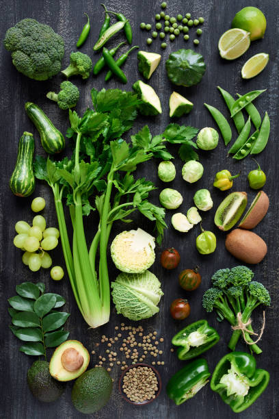 istock Spread of fresh green produce on dark rustic distressed background 928837142