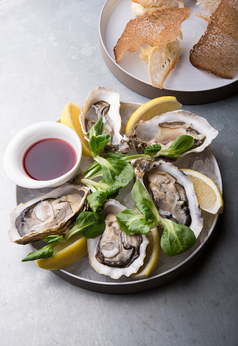 Oysters platter with lemon served with croutons