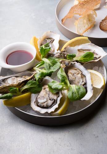 Oysters platter with lemon served with croutons
