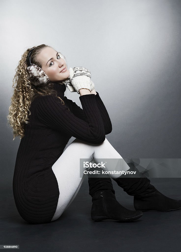 smiley woman in mitten and furs headphones  Adult Stock Photo