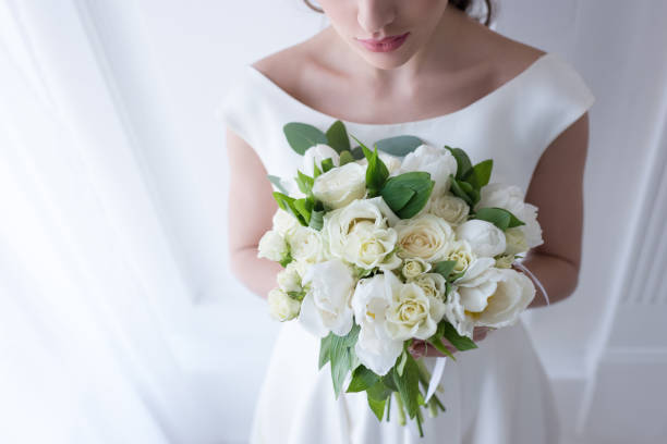 istock cropped view of bride holding wedding bouquet 928851266