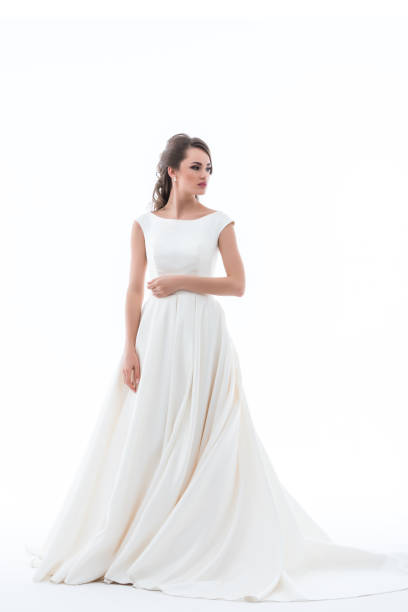 istock attractive elegant bride posing in traditional wedding dress, isolated on white 928852514