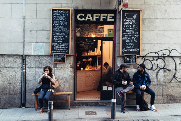 Madrid, Spain - November 3, 2017: People drinking coffee outside hipster cafe in Malasana district in Madrid.