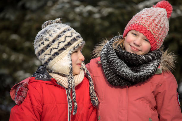 istock Kids in winter clothes in the woods 928862304