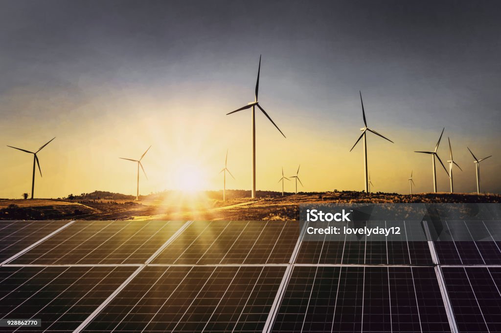 solar panels with wind turbine and sunset .concept power energy in nature Solar Energy Stock Photo