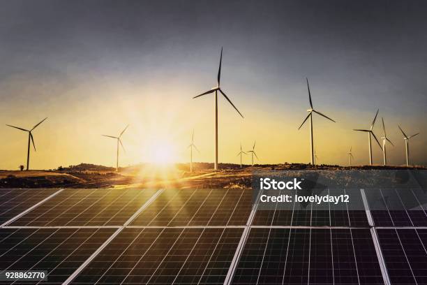 Solar Panels With Wind Turbine And Sunset Concept Power Energy In Nature Stock Photo - Download Image Now