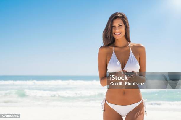 Woman In Bikini Using Phone Stock Photo - Download Image Now - Women, Beach, One Woman Only