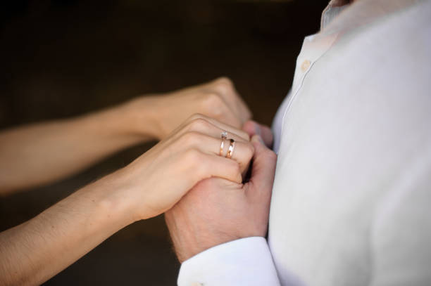 istock Groom in white shirt holding brides hands 928867134