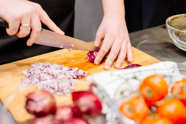 istock Woman cook cutting red onion 928869668