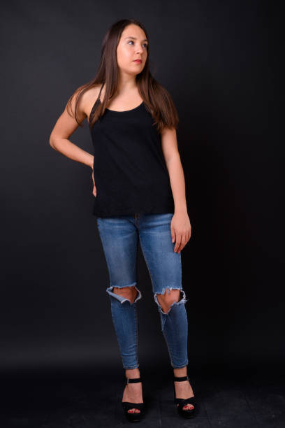 istock Young beautiful multi-ethnic woman against black background 928870602