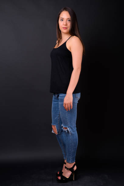 istock Young beautiful multi-ethnic woman against black background 928870860