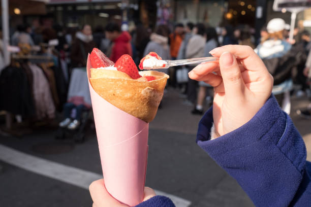 Point of view image eating sweets Point of view image with sweets in hands on Takeshita Street in Harajuku Tokyo Japan tokyo harajuku stock pictures, royalty-free photos & images