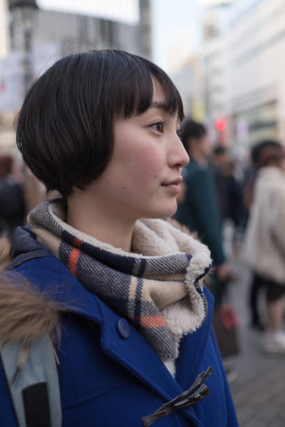 istock Young woman and crowd on crossing 928873396