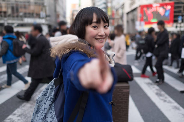 istock Young woman and crowd on crossing 928873426