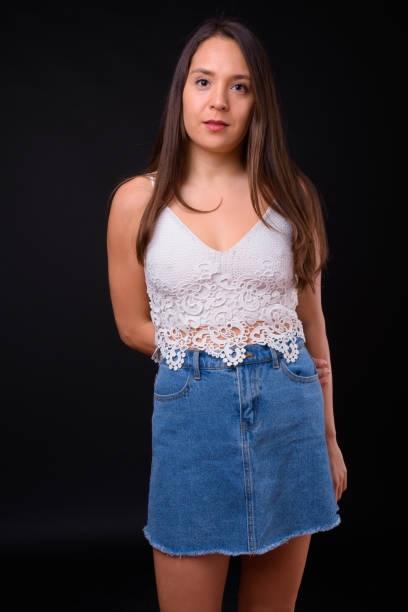 istock Young beautiful multi-ethnic woman against black background 928873570