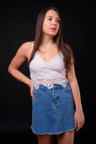 istock Young beautiful multi-ethnic woman against black background 928873572