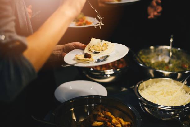 istock Woman decorating and eating mexican taco 928873586