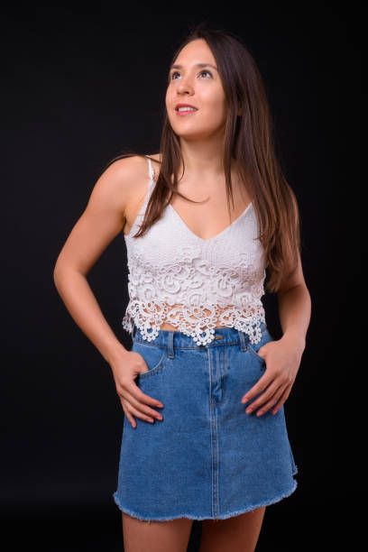 istock Young beautiful multi-ethnic woman against black background 928873640