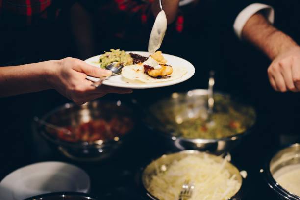 istock Woman decorating and eating mexican taco 928873656