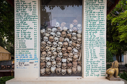 Cambodia,Siem Reap - April 7, 2014: The remains of the victims of the Khmer Rouge were displayed in a temple on the edge of the Angkor Wat area to remind the world not to forget the past. The remains were placed in a glass cabinet. The name and amount of the person who contributed the building temple were recorded on the wall.