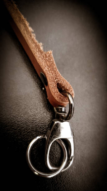 istock A beautiful brown hand made leather camera sling strap on a black background. 928873946