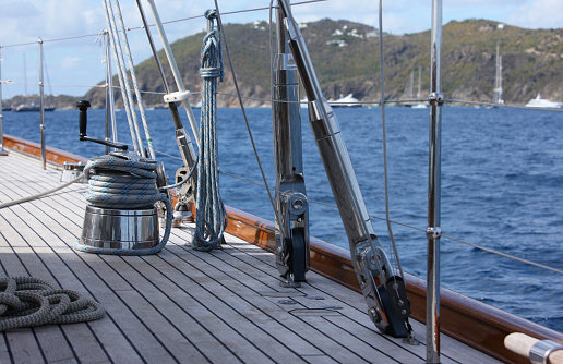 A majestic sailing ship's mast stands tall and proud against the backdrop of a brilliant blue sky, evoking a sense of freedom and adventure.