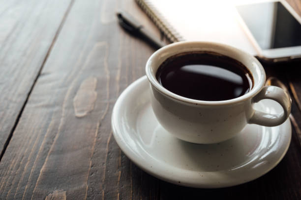 istock Cup of coffee on desk or workspace 928877144