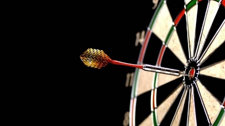 Dart hitting bull's eye, slow motion