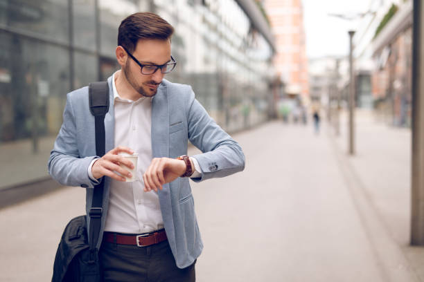 istock Businessman checking the time on his wristwatch 928882052