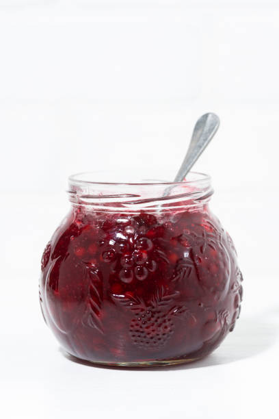 istock jar with cowberry jam on white background, vertical 928883434