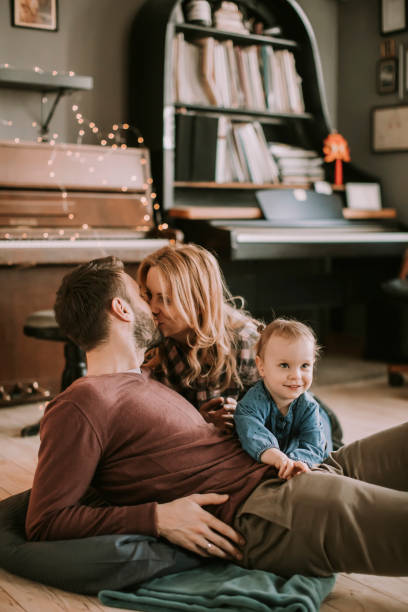 istock Happy young family playing on the floor 928890788