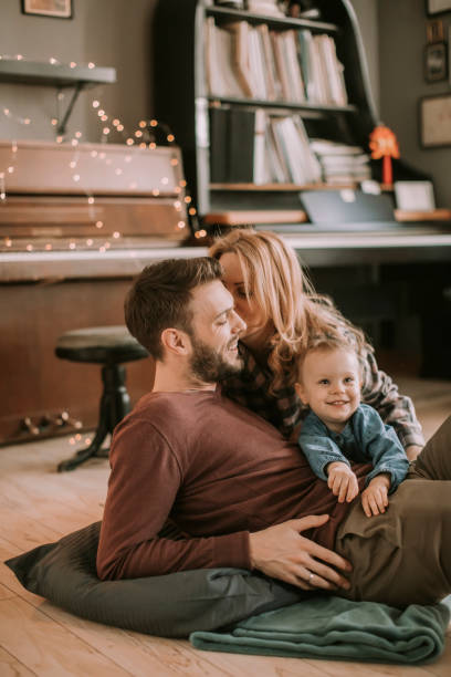 istock Happy young family playing on the floor 928890790