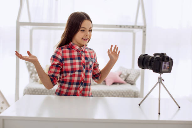 istock Cheerful girl communicating with her audience while recording vlog 928891126