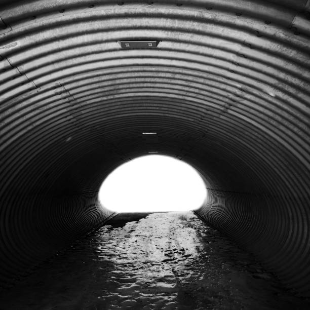 istock Corrugated steel corridor with glowing end 928891152