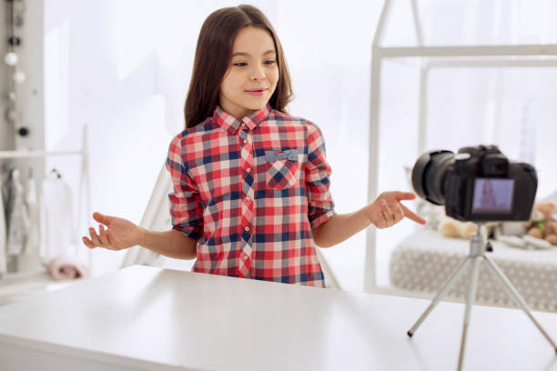 istock Joyful girl telling about her day in her vlog 928891210
