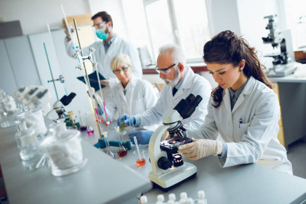 istock Team of scientists in research laboratory conducting science experiments 928891398