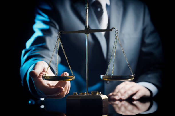 istock Weight scale of justice, lawyer in background 928894900