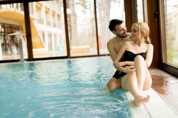 istock Loving couple relaxing in the spa by the pool 928895794