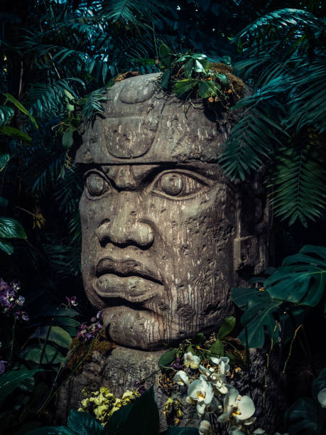 istock Olmec sculpture carved from stone. Big stone head statue in a jungle 928898144