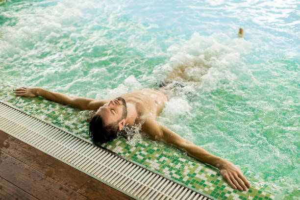 istock Handsome young man relaxing in hot tub 928898250