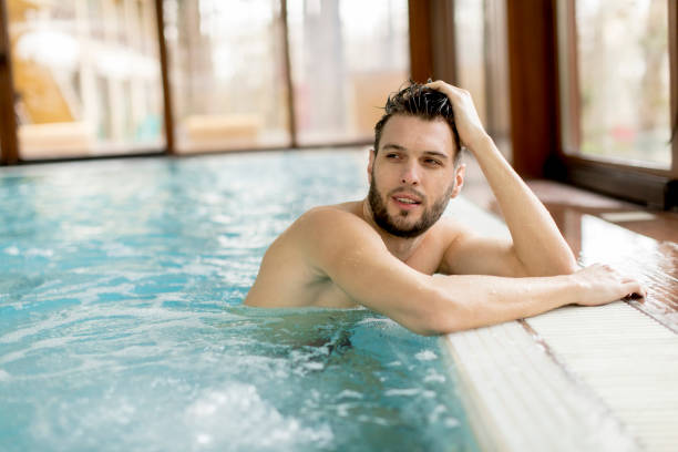 istock Handsome young man relaxing in the pool 928898260