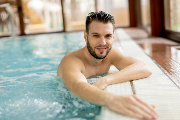 istock Handsome young man relaxing in the pool 928898262