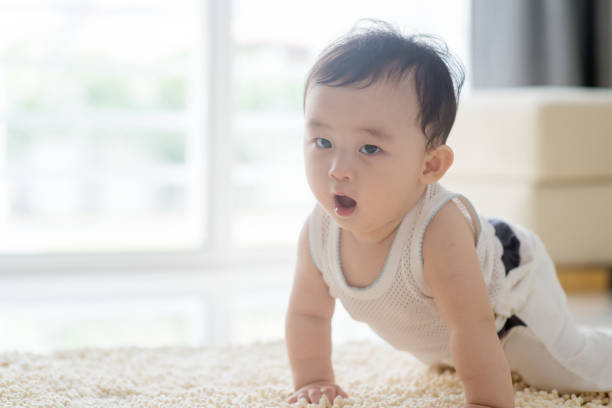 istock Cute baby boy crawling on carpet. 928899510
