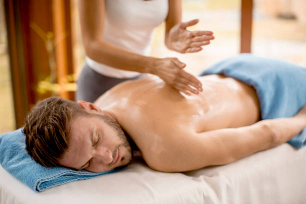 istock Young man having massage in the spa 928899542