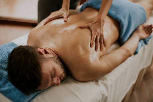 istock Young man having massage in the spa 928899544