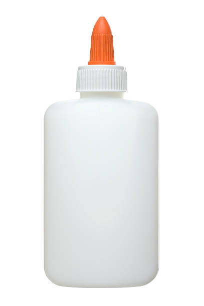 An unlabelled white and orange glue bottle A glue bottle isolated on white. glue stock pictures, royalty-free photos & images